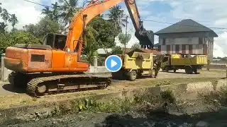 Dump Truck Excavator Busy Working on Cleaning Blocked Drains.